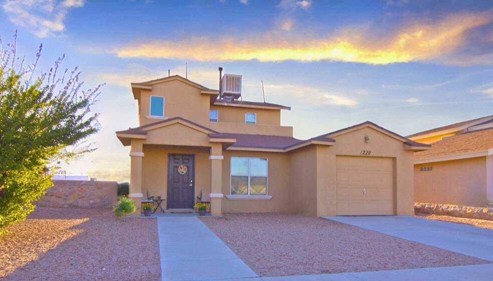 a house with a sunset in the background